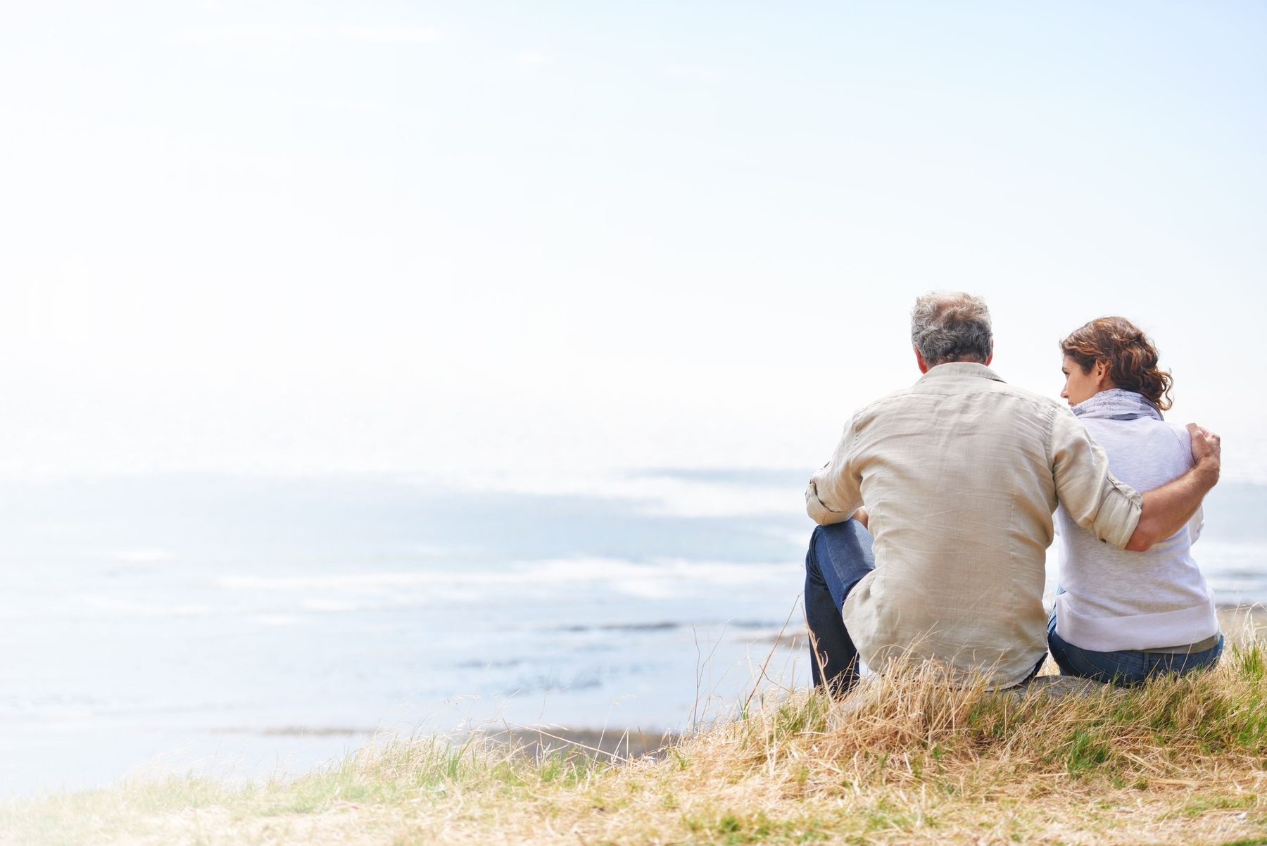 A couple looking out over the coast, planning their retirement together